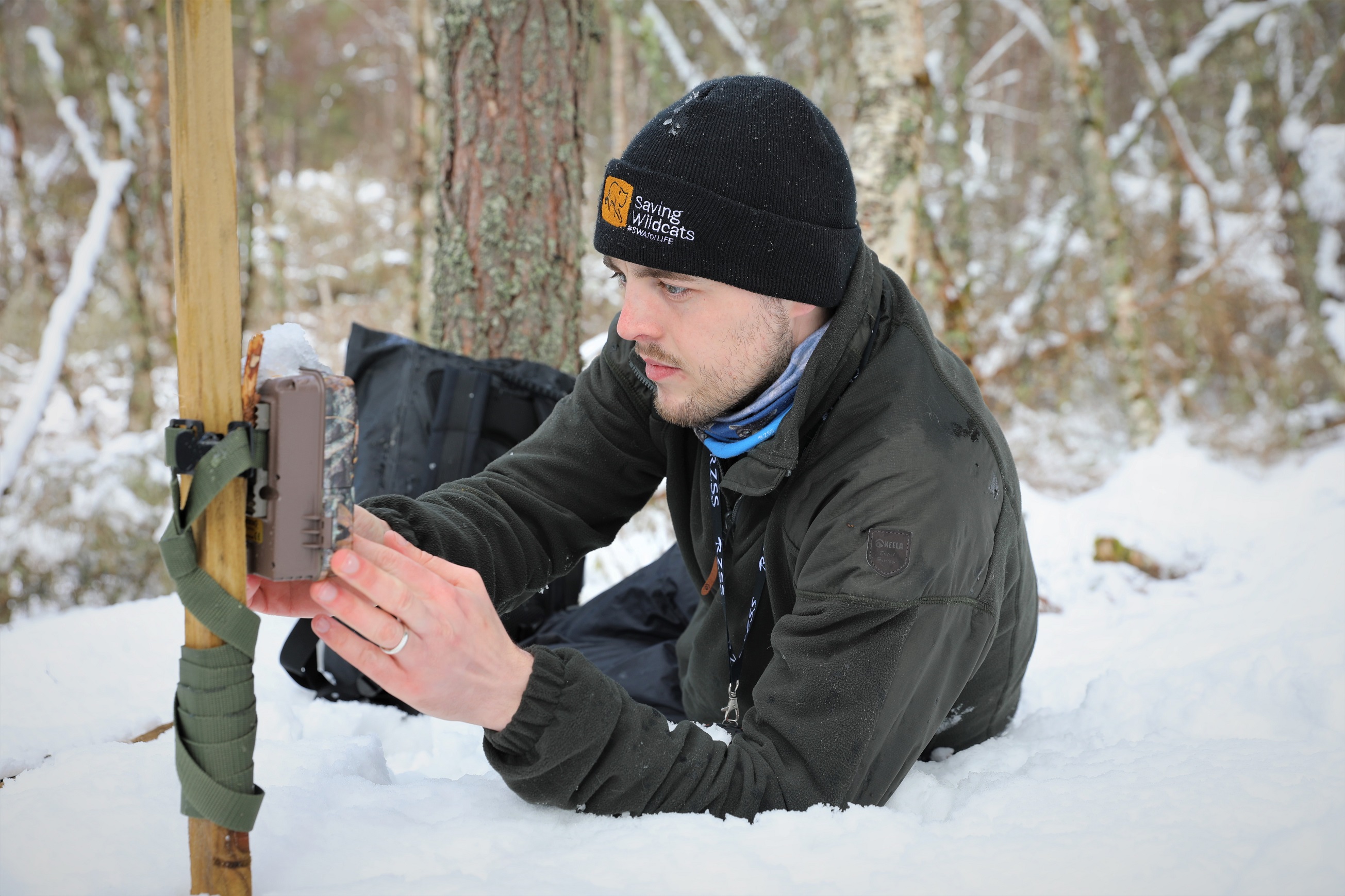 Saving Wildcats field worker Jamie Sneddon fitting a camera trap in the snow

March 2022 